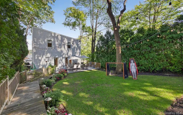 a view of a house with a yard and sitting area