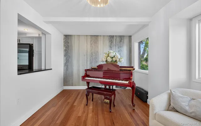 a living room with furniture and a piano