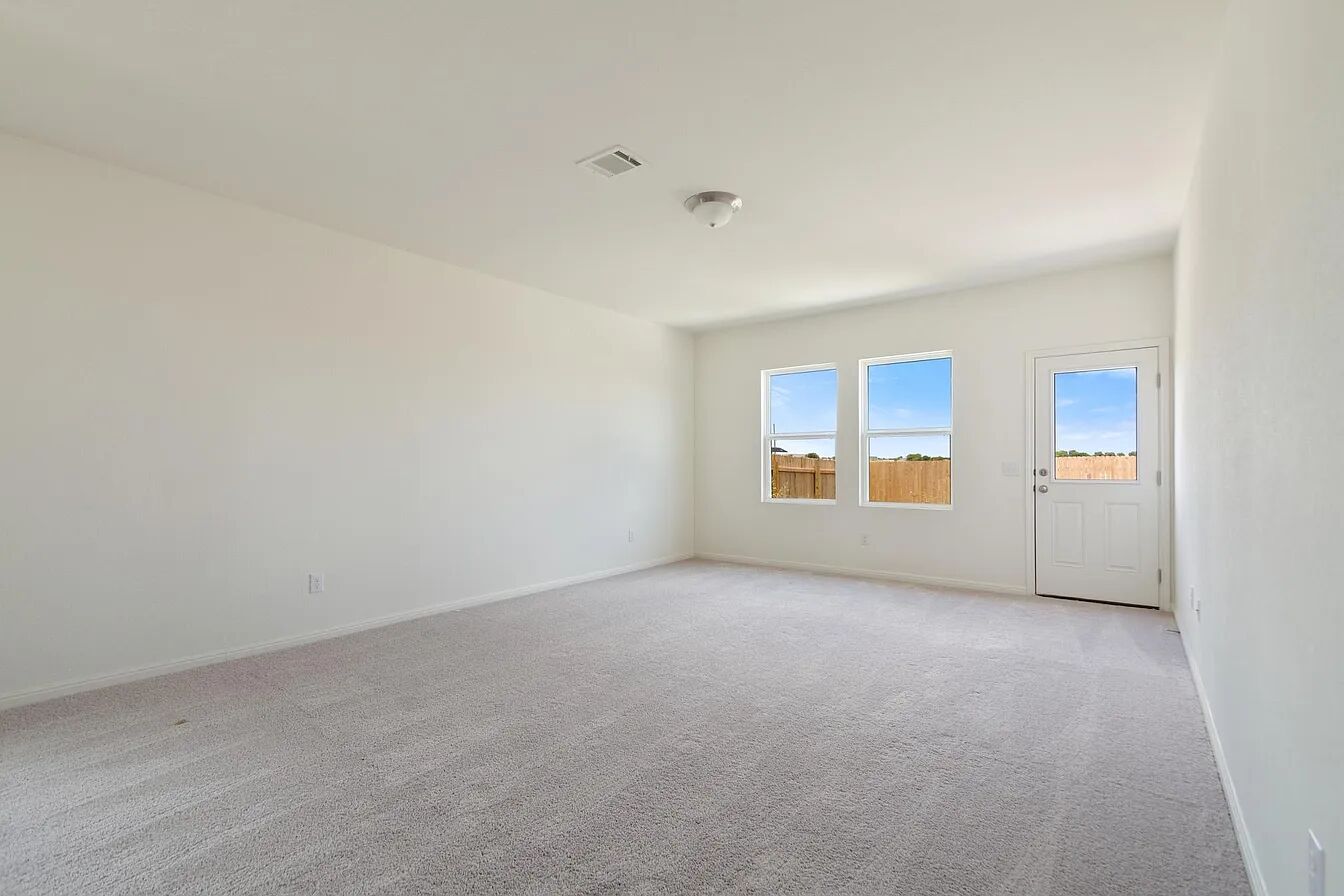 101 Aoudad Road Hutto, TX 78634 - Photo 23 of 39 A spacious, naturally illuminated room featuring clean, new carpeting and convenient outdoor access.