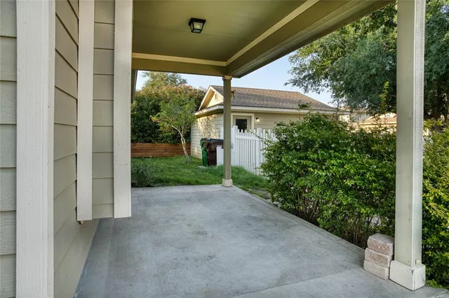 a view of a house with porch and garden