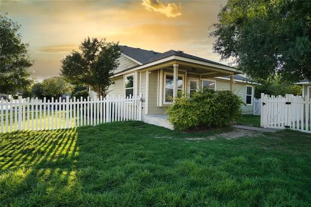 a front view of a house with a garden