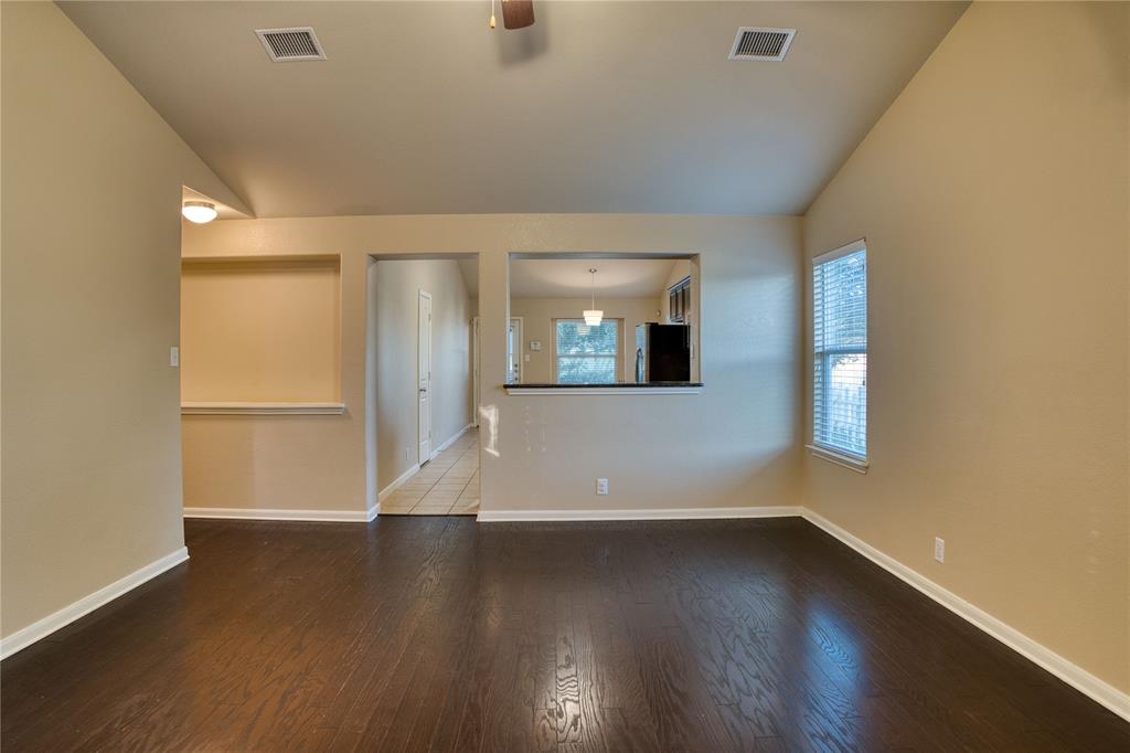 821 Gabriel Mills Drive Round Rock, TX 78664 - Photo 3 of 15 an empty room with wooden floor and windows