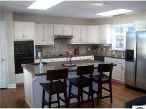 141 Surfside Road Mooresville, NC 28117 - Photo 5 of 16 a kitchen with stainless steel appliances granite countertop a dining table chairs refrigerator and sink