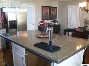 141 Surfside Road Mooresville, NC 28117 - Photo 6 of 16 a kitchen with kitchen island granite countertop a counter top space and cabinets