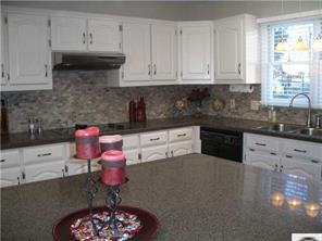 141 Surfside Road Mooresville, NC 28117 - Photo 7 of 16 a kitchen with stainless steel appliances granite countertop a sink stove and cabinets
