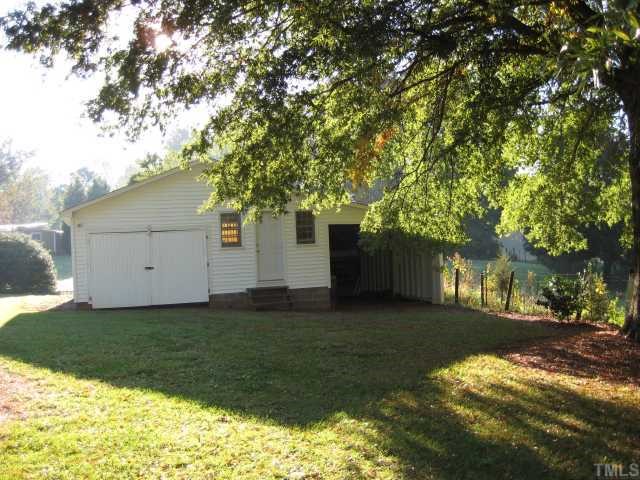 4135 Mebane Rogers Road Mebane, NC 27302 - Photo 11 of 12 This detached workshop with 2 additional bays has vinyl siding. The building is wired and would be a great space for a hobby area, workshp or art studio.