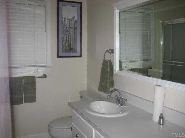 4135 Mebane Rogers Road Mebane, NC 27302 - Photo 10 of 12 View of full bath in hall with white painted cabinets, new drawer pulls, and updated mirror.