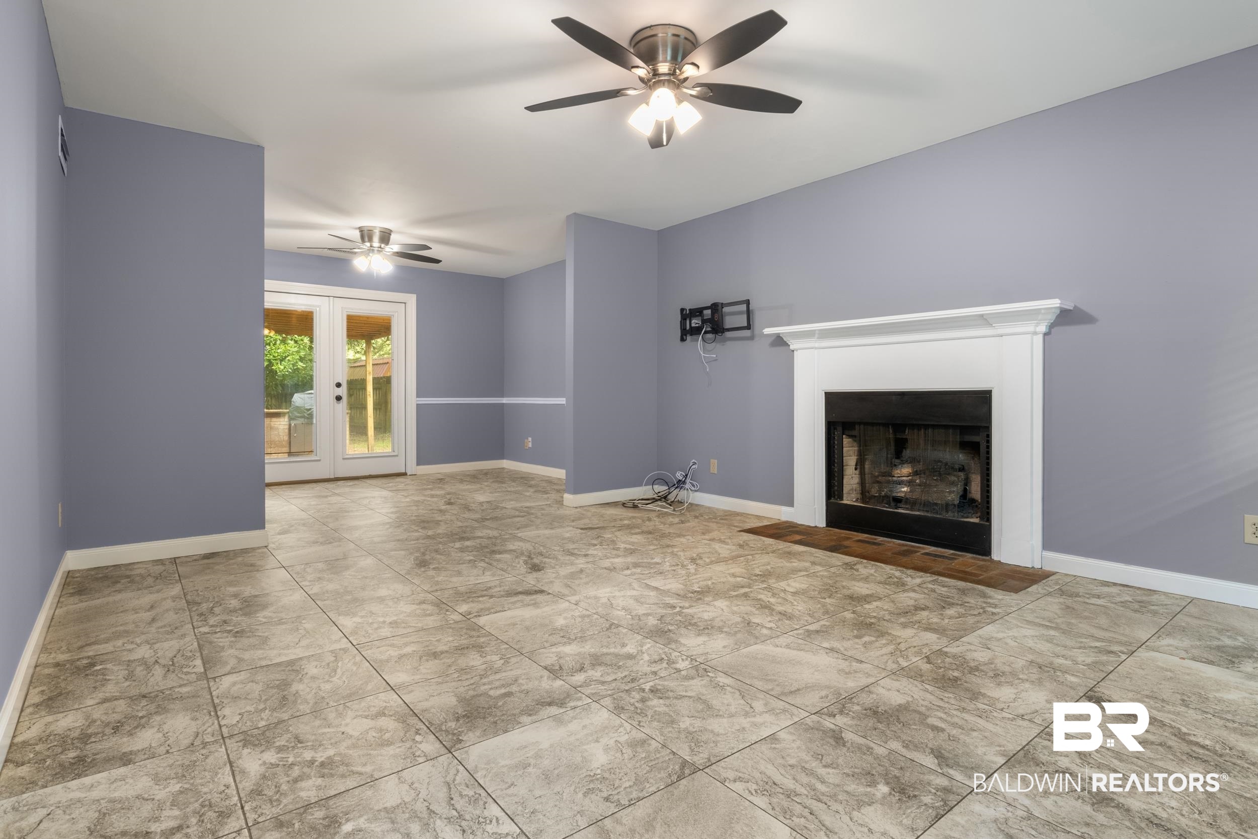 150 Montclair Loop Daphne, AL 36526 - Photo 13 of 29 Unfurnished living room featuring french doors, ceiling fan, and light tile floors