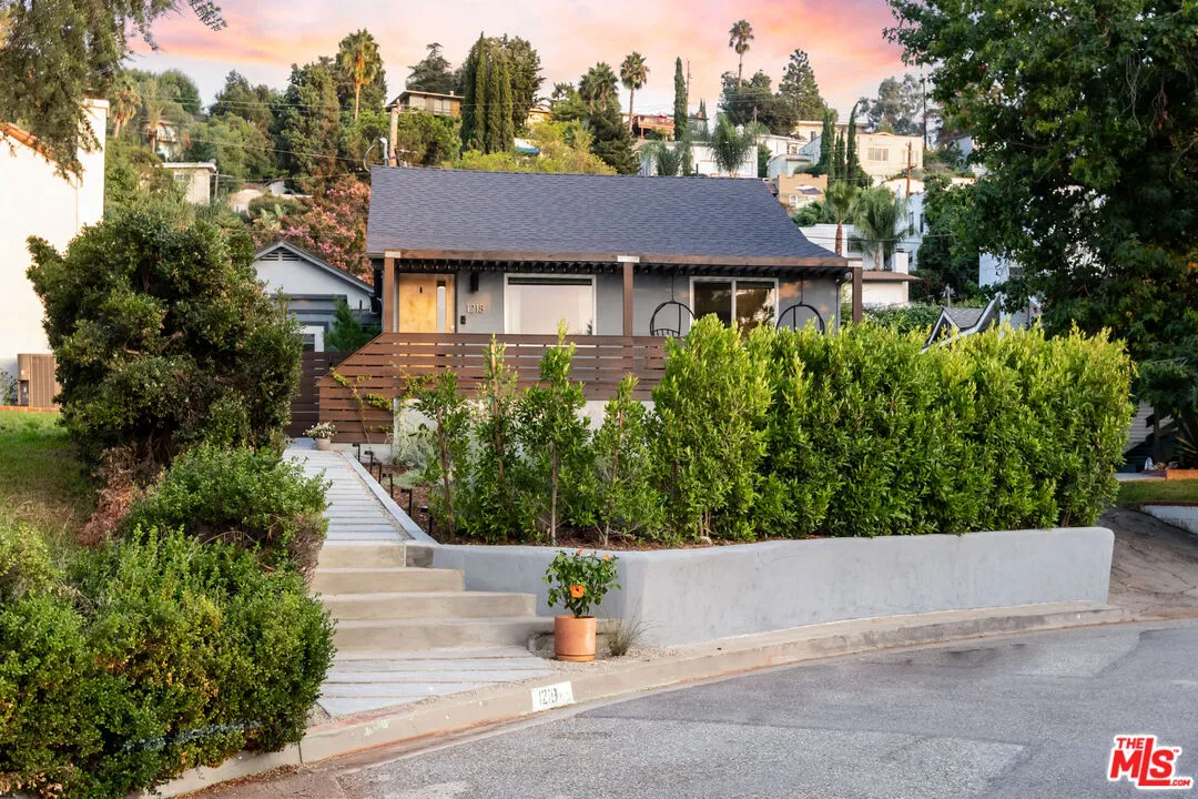 a view of a house with potted plants