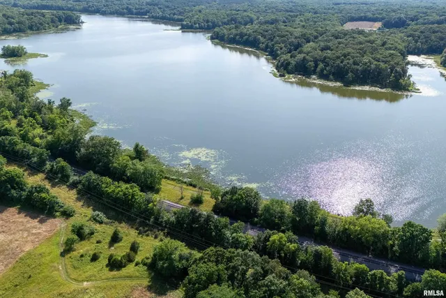 an aerial view of lake and residential houses with outdoor space