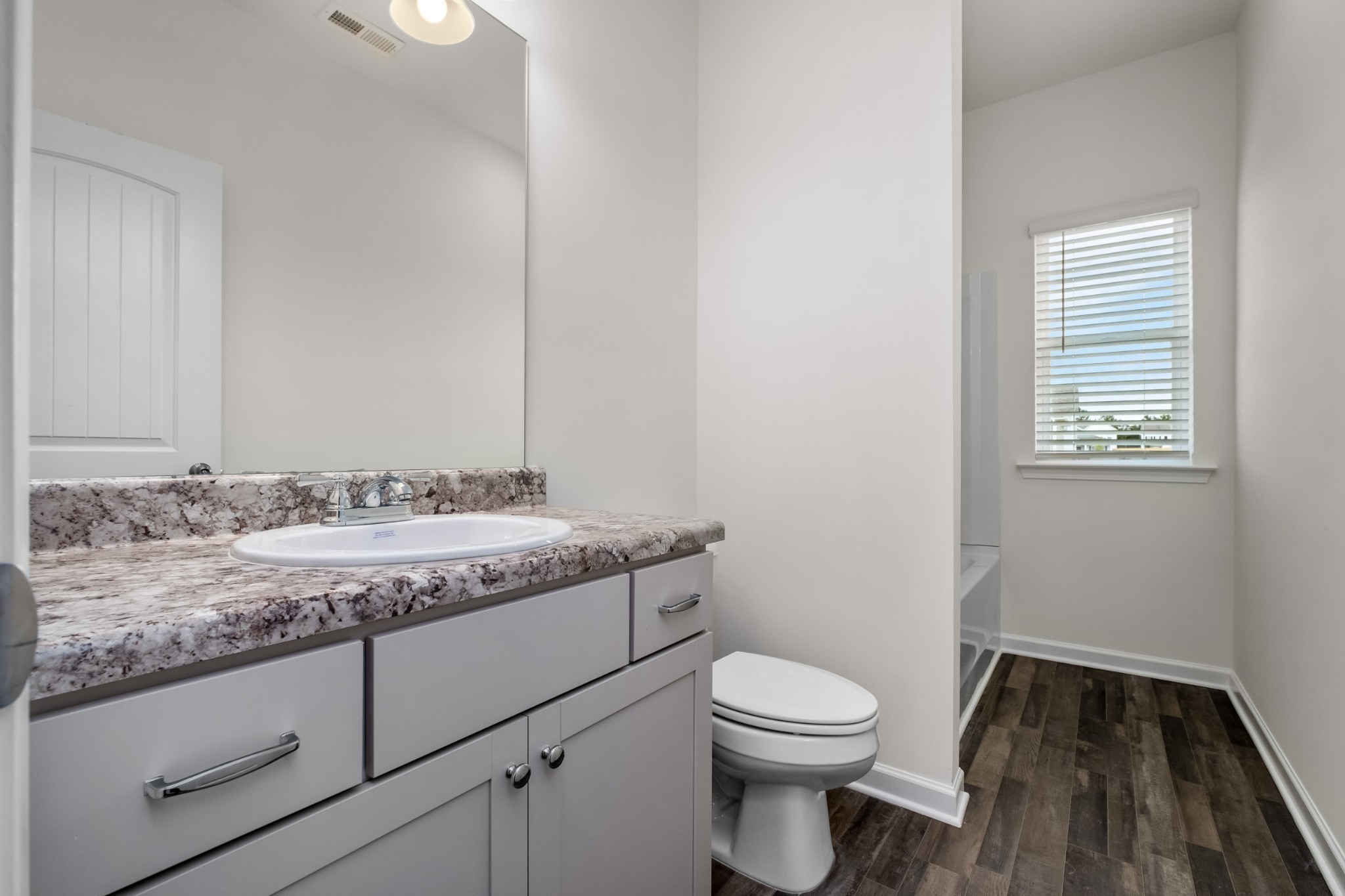 348 Winston Way Gallatin, TN 37066 - Photo 14 of 26 a bathroom with a granite countertop toilet sink and mirror