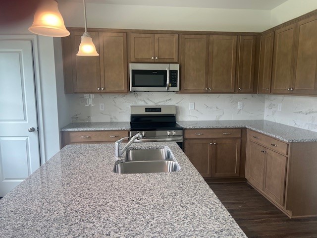 348 Winston Way Gallatin, TN 37066 - Photo 26 of 26 a kitchen with granite countertop a sink dishwasher a stove and a microwave oven with cabinets