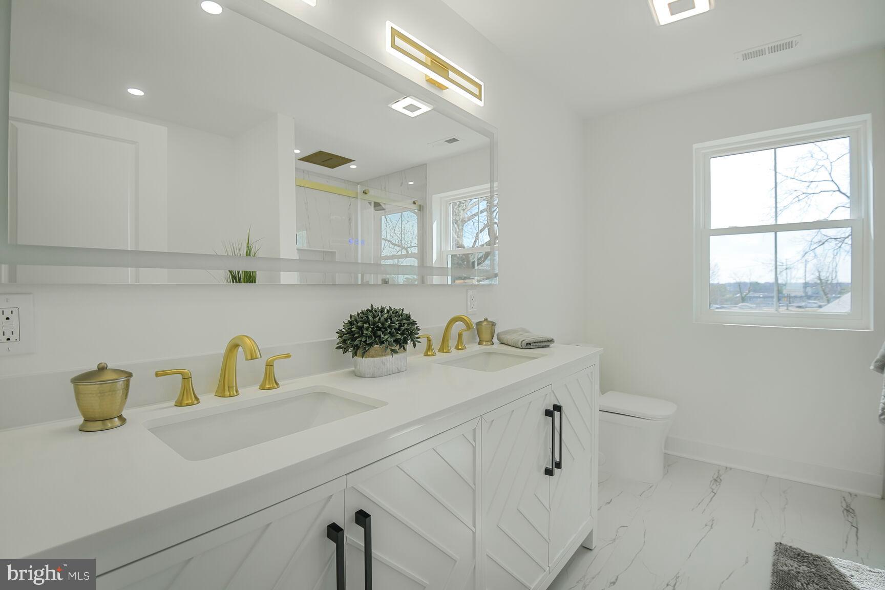 1612 Noyes Drive Silver Spring, MD 20910 - Photo 15 of 37 a kitchen with a sink a stove cabinets and a window