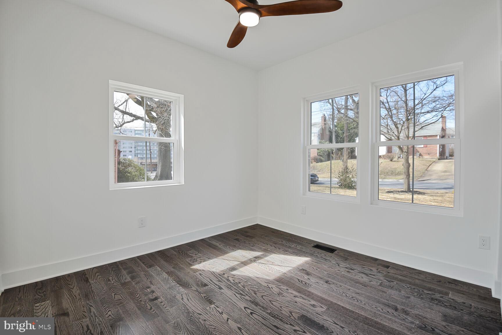 1612 Noyes Drive Silver Spring, MD 20910 - Photo 18 of 37 an empty room with wooden floor fan and windows