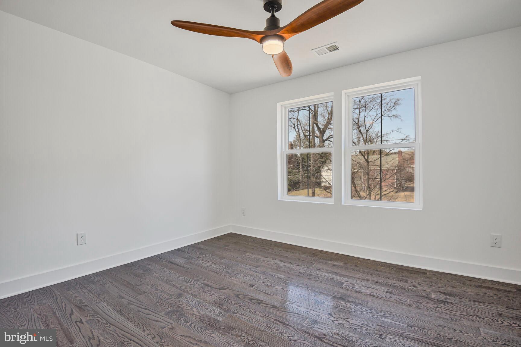 1612 Noyes Drive Silver Spring, MD 20910 - Photo 19 of 37 a view of an empty room with wooden floor and a window
