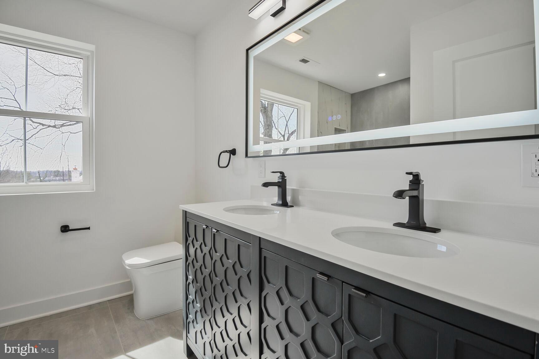 1612 Noyes Drive Silver Spring, MD 20910 - Photo 20 of 37 a bathroom with a sink and a toilet