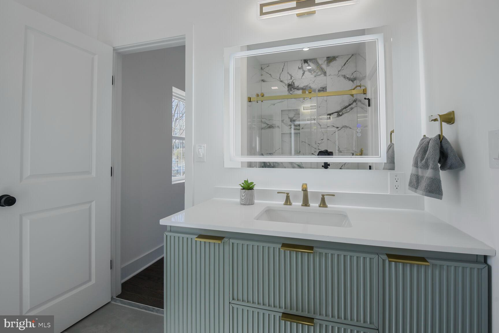 1612 Noyes Drive Silver Spring, MD 20910 - Photo 22 of 37 a bathroom with a sink and a mirror