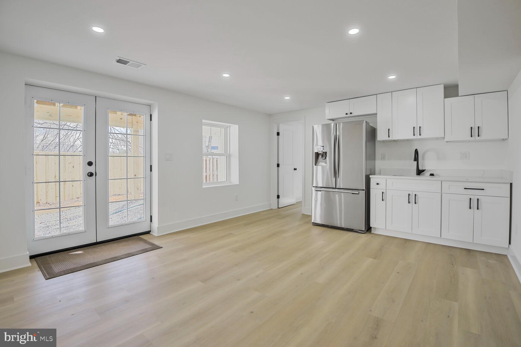 1612 Noyes Drive Silver Spring, MD 20910 - Photo 25 of 37 a view of an empty room with window and wooden floor