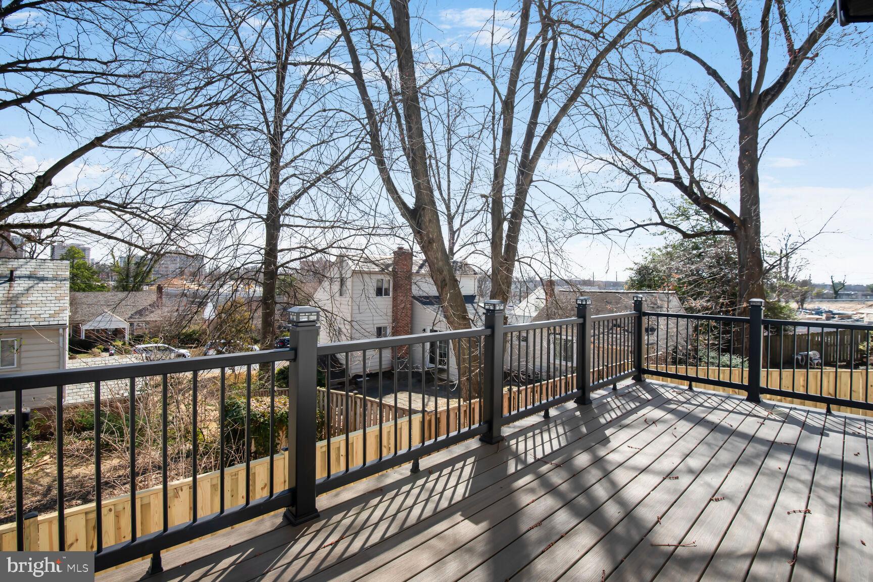 1612 Noyes Drive Silver Spring, MD 20910 - Photo 28 of 37 a view of a balcony with wooden fence and trees