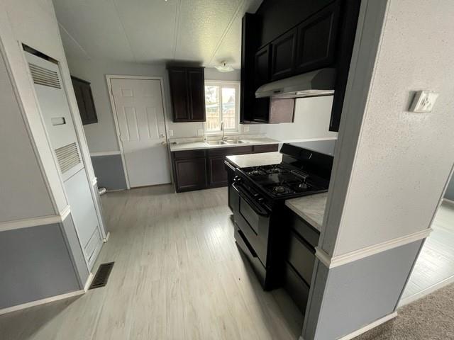 250 Davis Street Turlock, CA 95380 - Photo 5 of 11 a kitchen with stainless steel appliances a stove a sink and a refrigerator