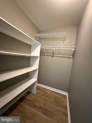 an empty room with a window and ceiling fan