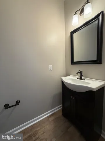 a bathroom with a double vanity sink mirror and toilet