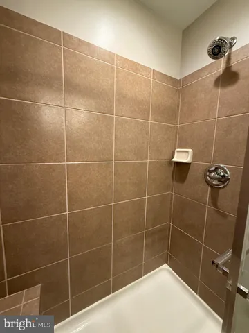 a bathroom with a glass shower door