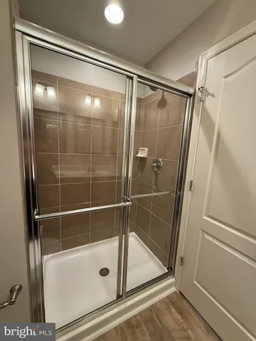 a bathroom with a sink a toilet a mirror and bathtub