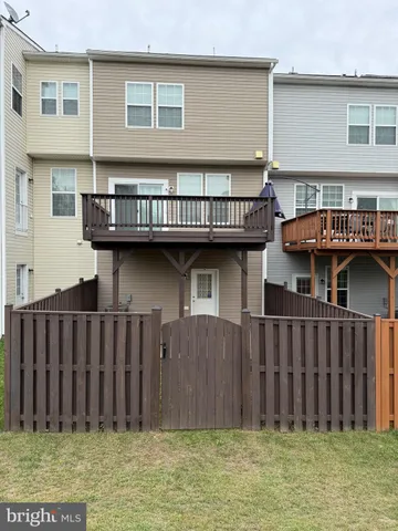 a view of a house with wooden fence