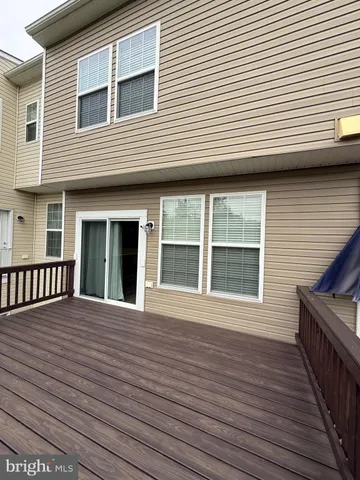 a view of a house with wooden deck