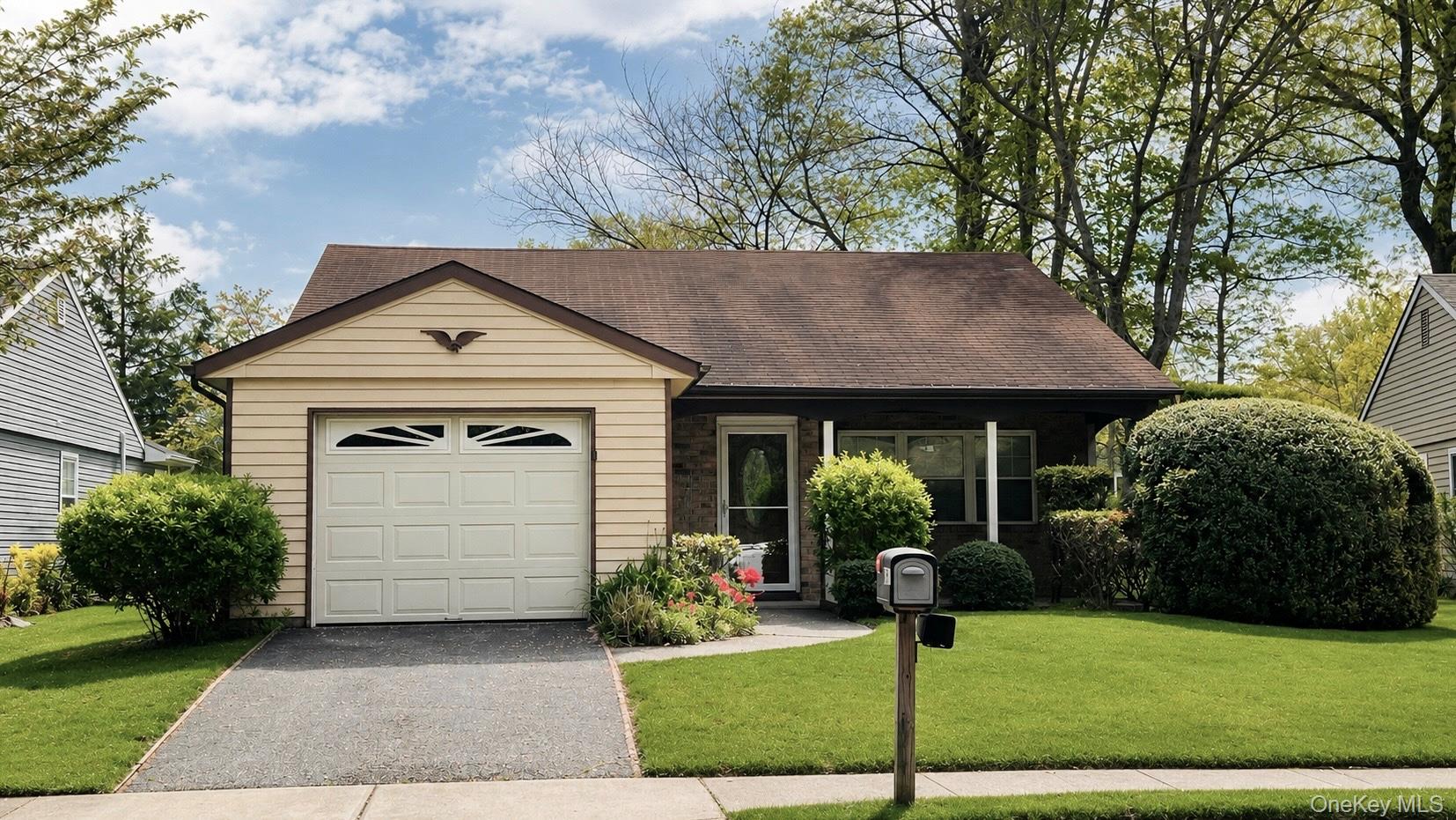 257 Edinburgh Drive Ridge, NY 11961 - Photo 1 of 10 a front view of a house with garden