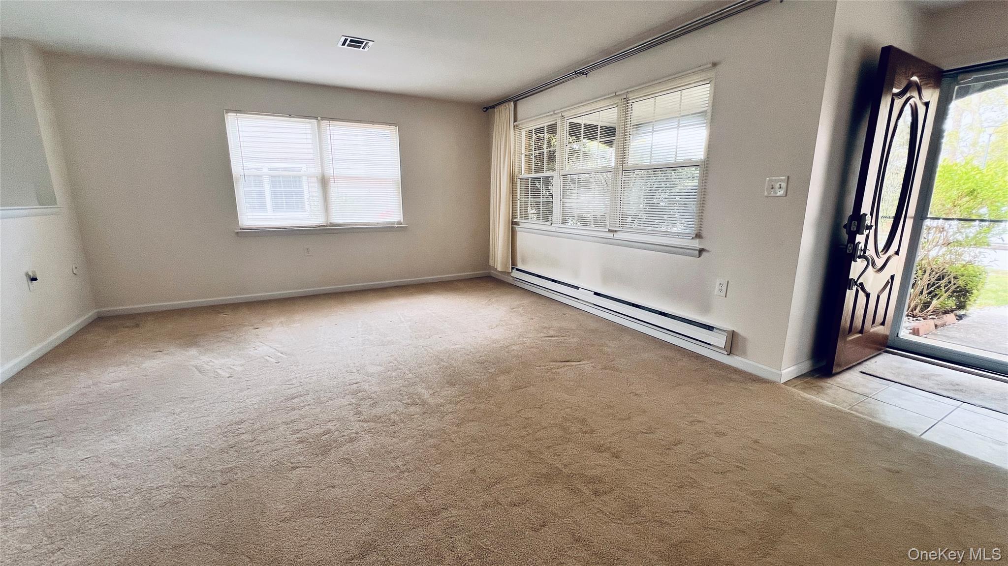 257 Edinburgh Drive Ridge, NY 11961 - Photo 4 of 10 an empty room with windows