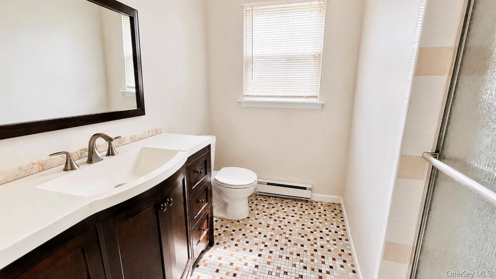 257 Edinburgh Drive Ridge, NY 11961 - Photo 9 of 10 a bathroom with a sink and a mirror