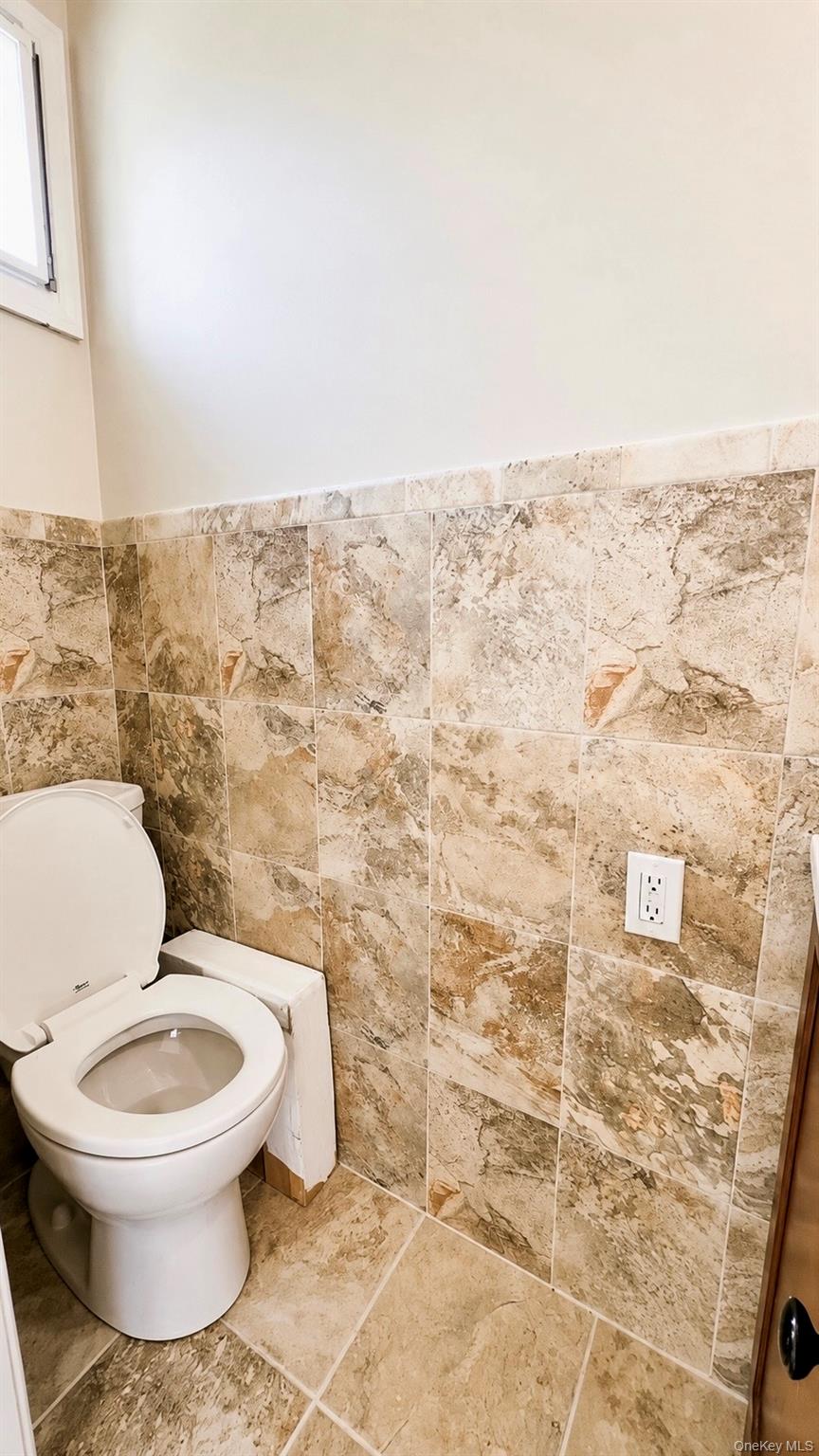 257 Edinburgh Drive Ridge, NY 11961 - Photo 10 of 10 a white toilet sitting next to a shower