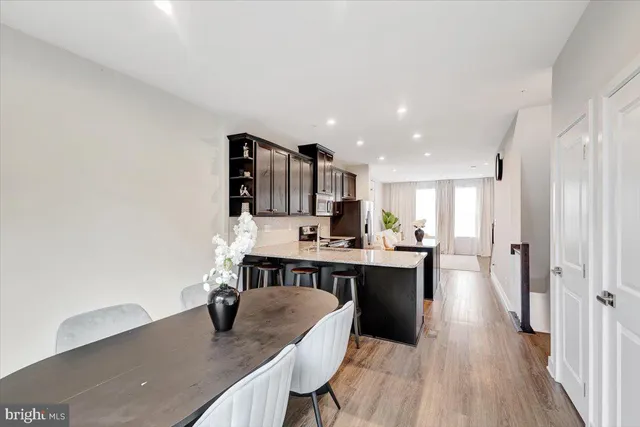 a kitchen with kitchen island stainless steel appliances a sink and cabinets
