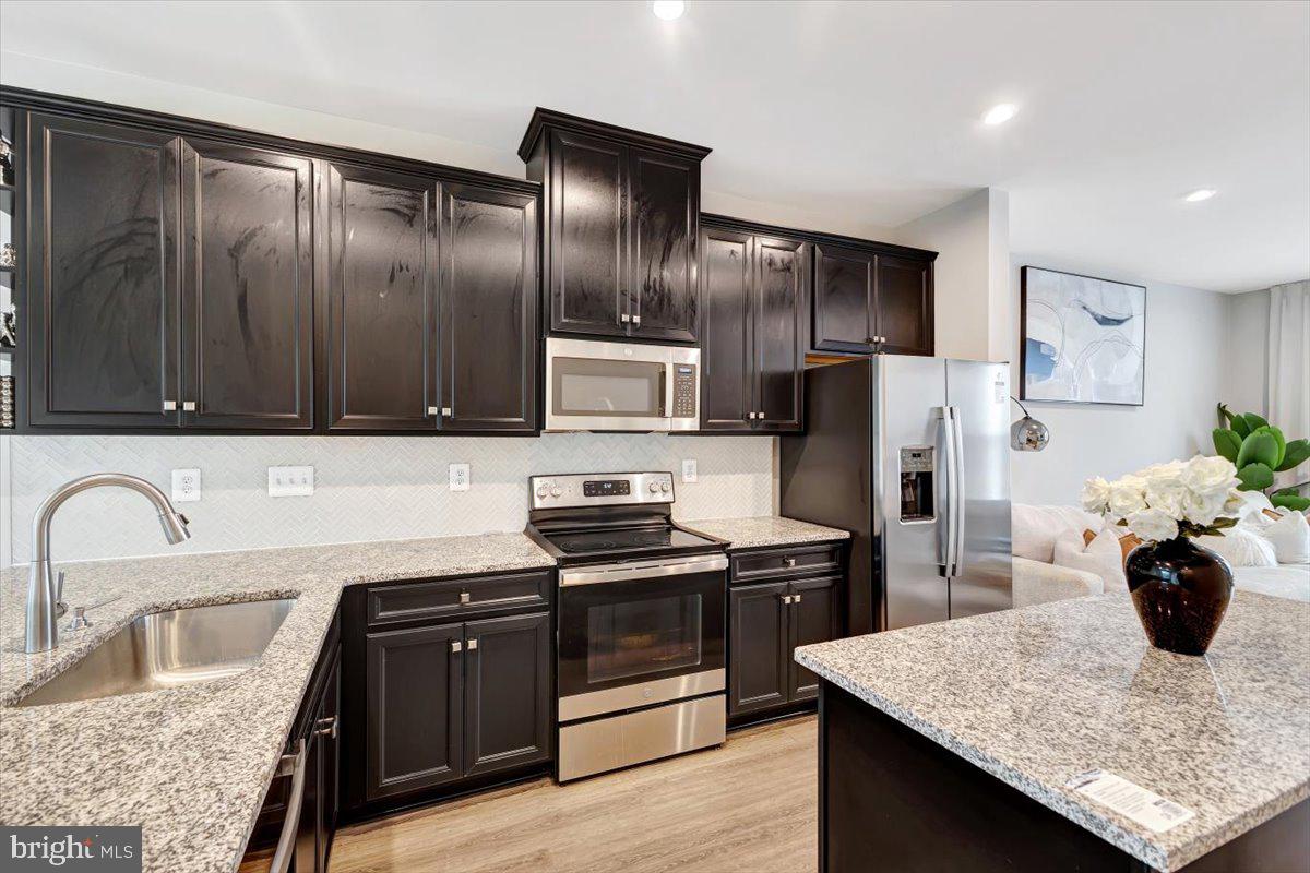 7157 Smoke Stack Road Baltimore, MD 21222 - Photo 12 of 27 a kitchen with refrigerator and stove