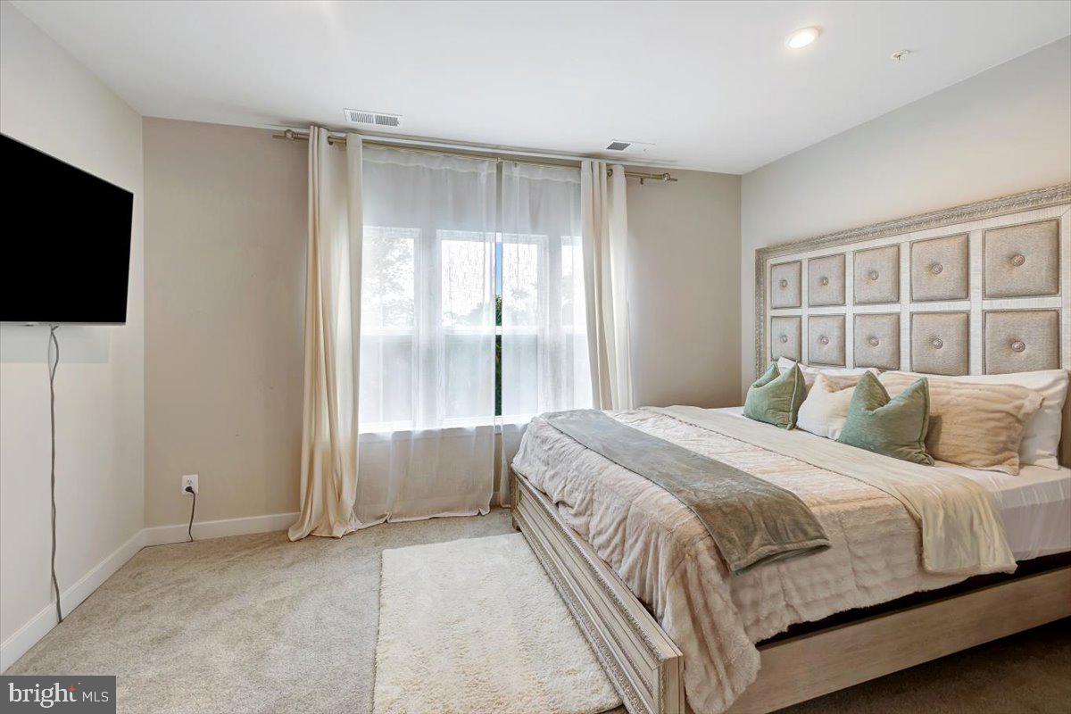 7157 Smoke Stack Road Baltimore, MD 21222 - Photo 16 of 27 a bedroom with a bed and a flat screen tv