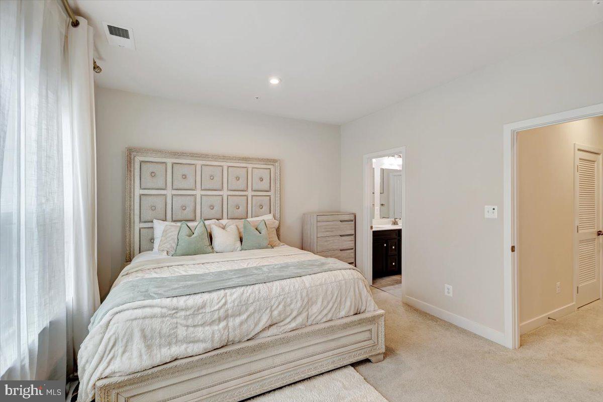 7157 Smoke Stack Road Baltimore, MD 21222 - Photo 17 of 27 a bedroom with a large bed and a chandelier