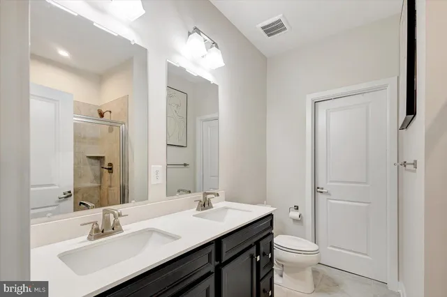 a bathroom with a sink toilet a mirror and vanity