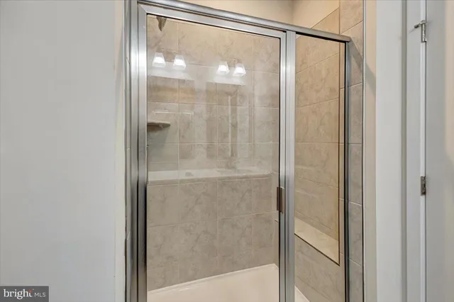 a bathroom with a glass shower door