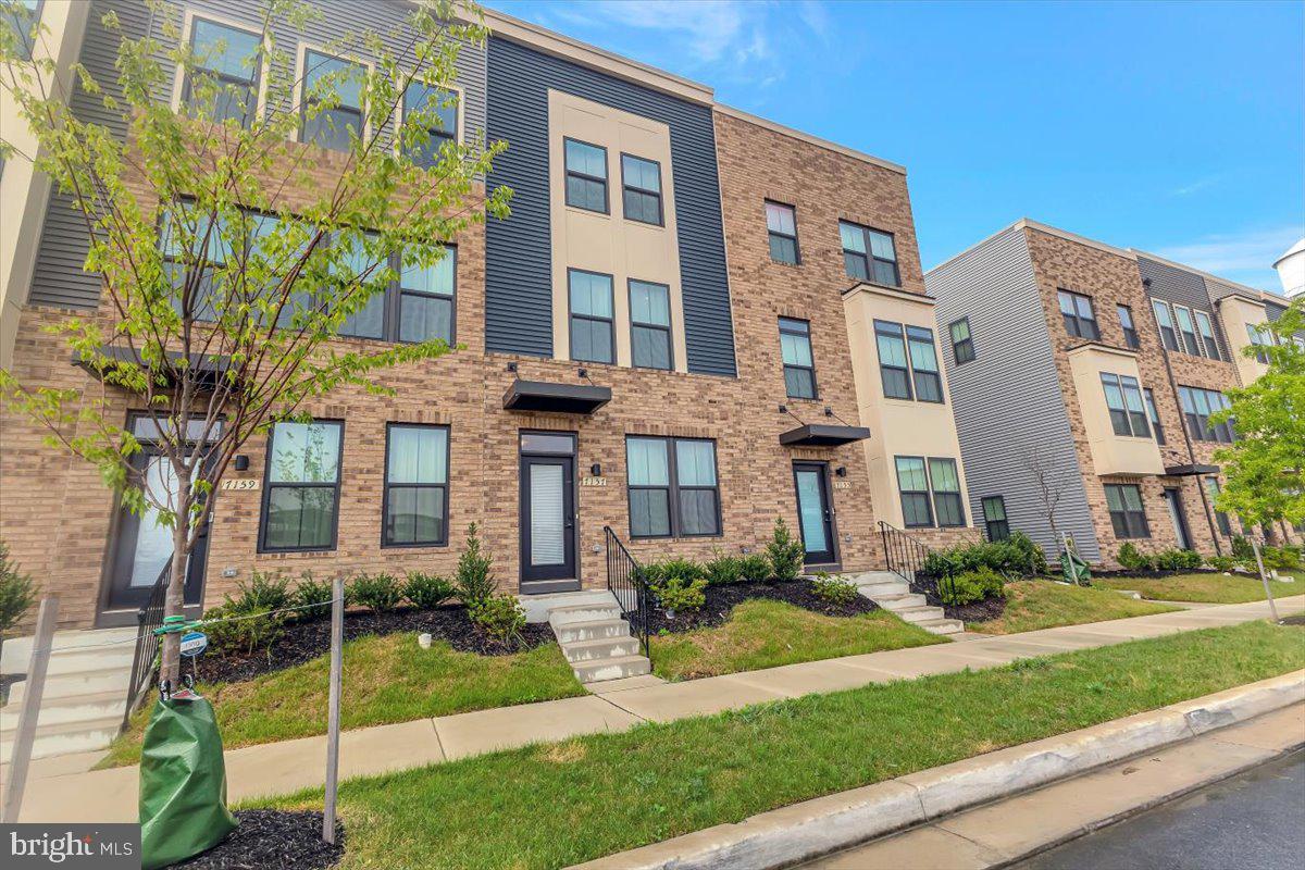 7157 Smoke Stack Road Baltimore, MD 21222 - Photo 2 of 27 front view of a brick house with a yard