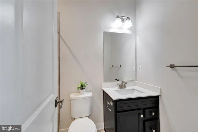 a bathroom with a sink toilet and a mirror