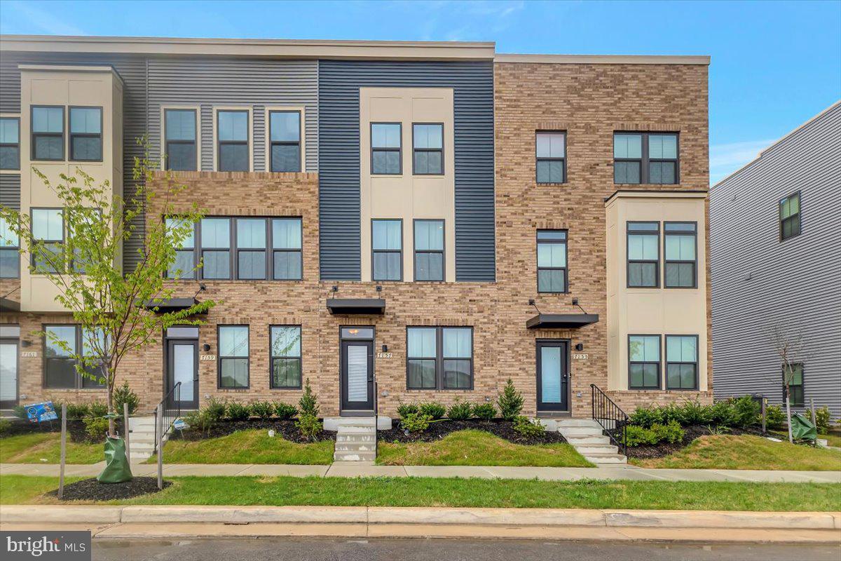 7157 Smoke Stack Road Baltimore, MD 21222 - Photo 27 of 27 a front view of a brick building next to a yard