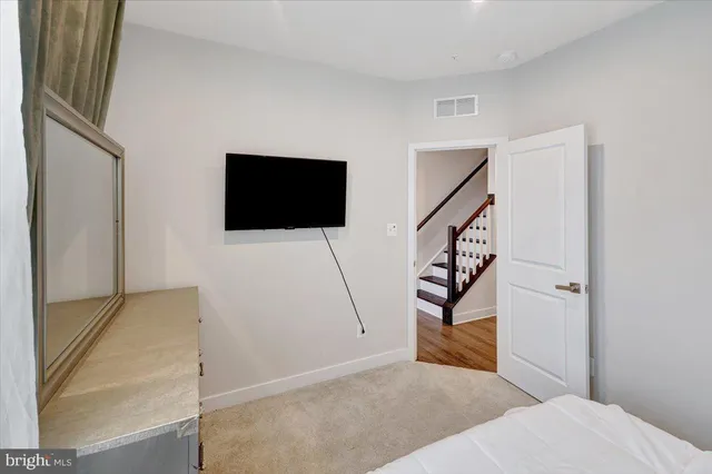 a view of a livingroom with stairs and furniture