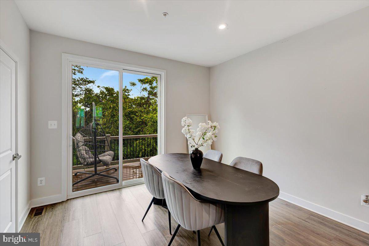 7157 Smoke Stack Road Baltimore, MD 21222 - Photo 9 of 27 a view of a dining room with furniture window and wooden floor