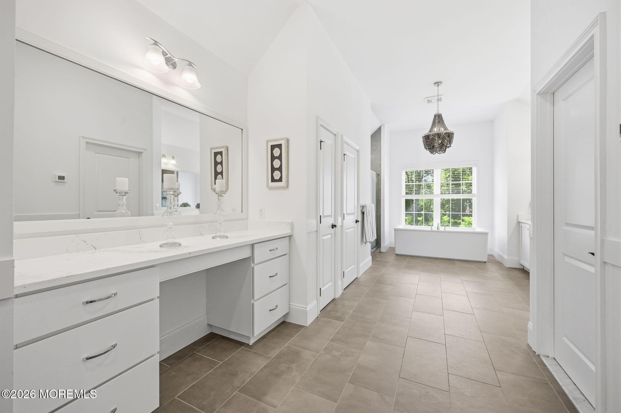 66 Windermere Road Lincroft, NJ 07738 - Photo 23 of 48 a spacious bathroom with a double vanity sink a mirror and a bathtub