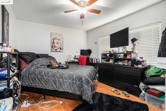 a bedroom with a bed window and a flat screen tv