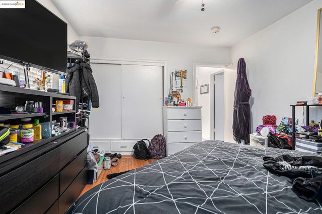 a bedroom with a bed window and a flat screen tv