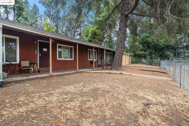 a backyard of a house with yard and outdoor seating