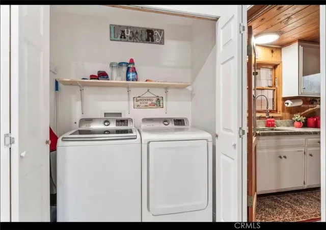 a utility room with closet dryer and washer